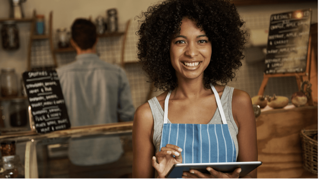 Business owner holding a tablet and enjoying a Successful Omnichannel Customer Experience Strategy