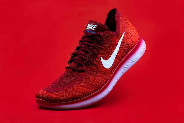 photo of red nike shoe on red background