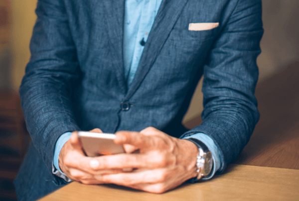 man using phone in sharp business suit