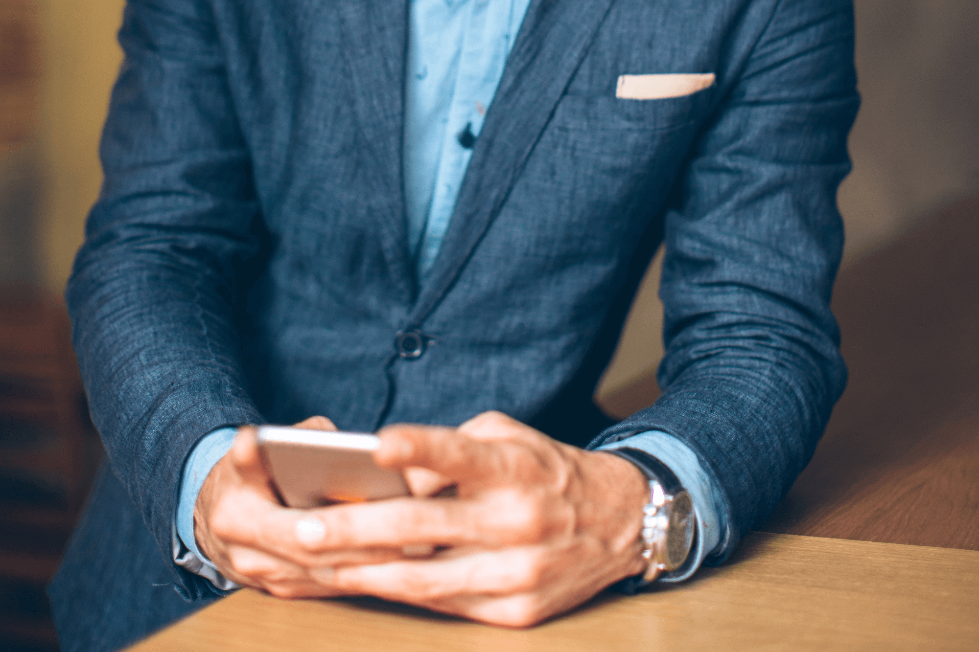 man using phone in sharp business suit